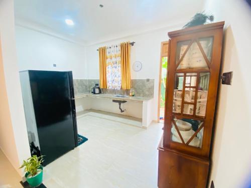 a living room with a cabinet and a window at Happy Haven in Hikkaduwa