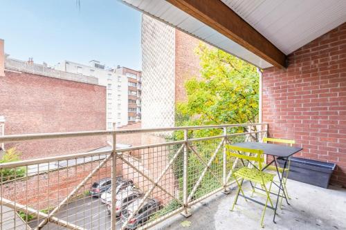a table and a chair on a balcony at 3 bedroom apartment with parking & balconies in La Madeleine