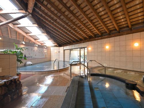 a large pool of water in a large building at Kochi Kuroshio Hotel in Konan