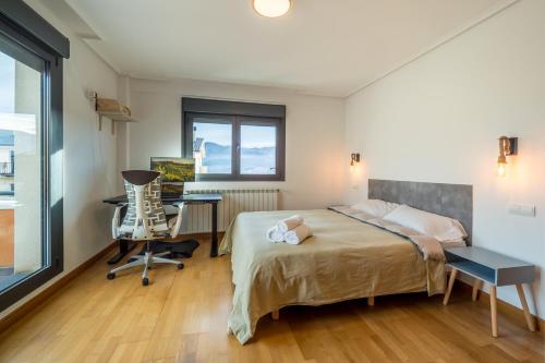 a bedroom with a bed and a desk and a chair at Casa Nea, tu hogar en La Rioja in Nalda