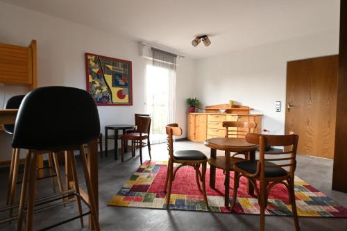 a living room with chairs and a table and a rug at Gästehaus Senger in Bestwig