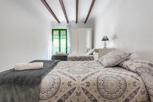 a bedroom with a large bed and a window at Bettatur Apartaments Rera Sant Domenech in Tarragona