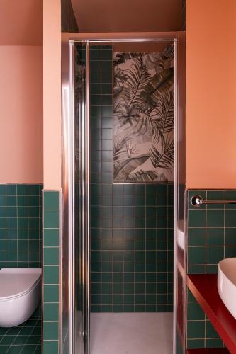 a bathroom with a shower with green tiles at Hotel Montecarlo in Rome
