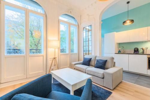 a living room with a couch and a table at 3 bedroom duplex apartment, city center in Lille