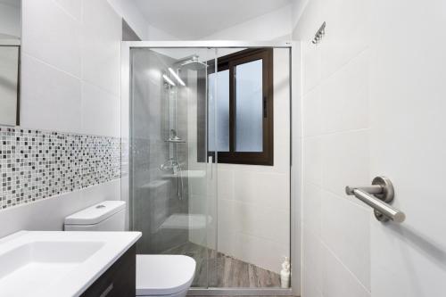 e bagno con doccia, servizi igienici e lavandino. di Home2Book Cozy Apt La Marina, Santa Cruz Center a Santa Cruz de Tenerife
