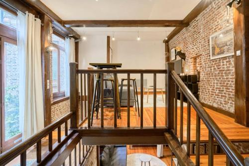 a staircase in a room with a brick wall at Atypical apartment in the heart of Old Lille! in Lille