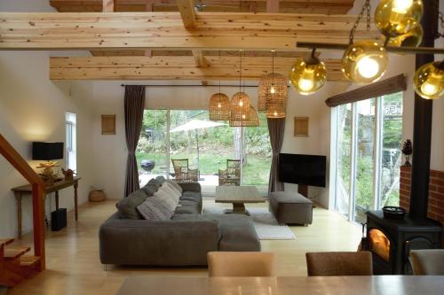 a living room with a large couch and a table at BBQ&焚火OK - the Hours KARUIZAWA in Karuizawa