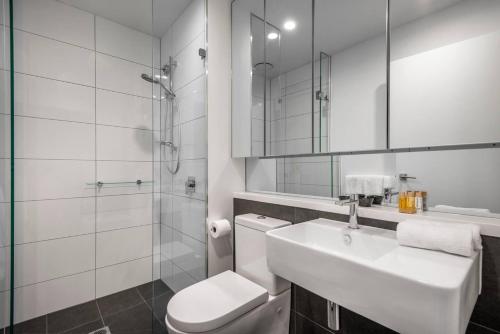 a bathroom with a sink and a toilet and a shower at Retro Modern with Pool near Westfield Doncaster in Doncaster