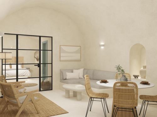 un soggiorno con divano, tavolo e sedie di Annouso Villa with Hot Tub by Caldera Houses a Oia