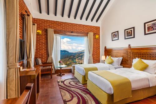 a hotel room with two beds and a window at Soaltee Westend Resort Nagarkot in Nagarkot