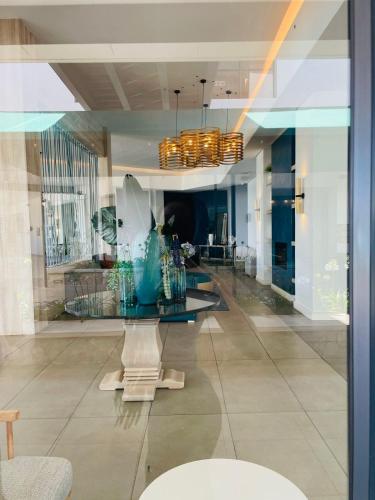a room with a glass table with vases on it at One Bedroom The Blyde in Pretoria