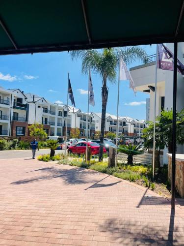 a group of flags in front of a building at One Bedroom The Blyde in Pretoria