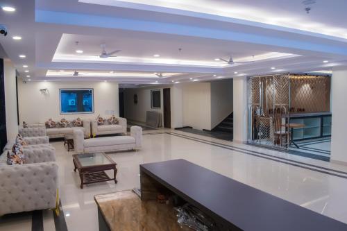 a large living room with couches and a fireplace at HOTEL YASH PALACE Near IGI Airport in New Delhi