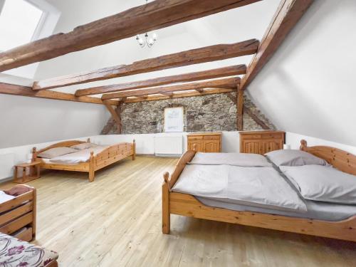 1 dormitorio con 2 camas y suelo de madera en Marcelína, en Mikulov v Krušných Horách