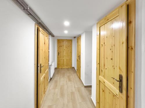 a hallway with wooden doors and wooden floors at Marcelína in Mikulov v Krušných Horách