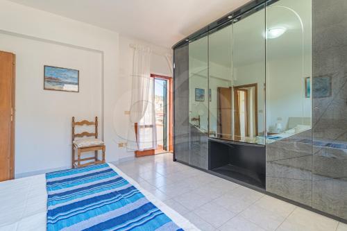 a bedroom with a large glass shower and a bed at La Rondine su Seccheto - Goelba in Seccheto
