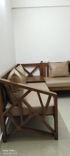 a coffee table and a couch with pillows on it at VV ROOMS cochin internationalairport in Nedumbassery