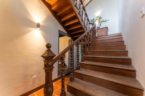 a staircase with wooden treads and a wooden railing at The Dutch Bungalow in Galle