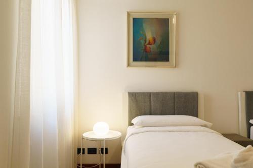 Ένα ή περισσότερα κρεβάτια σε δωμάτιο στο Domus Verona - Residenza Marconi