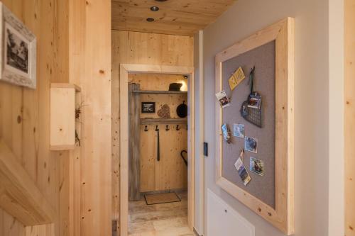 a hallway with a door into a room with wooden walls at Chalet Jochwand Bad Goisern in Bad Goisern