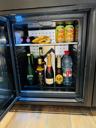 a refrigerator filled with lots of bottles of alcohol at Les secrets d'Eros - DAX in Dax