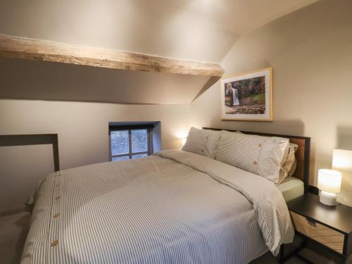 a bedroom with a large bed and a window at 8 Oak Cottages in Lancaster