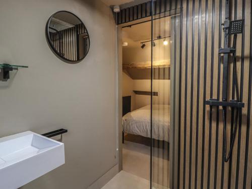 a bathroom with a glass shower and a sink at 8 Oak Cottages in Lancaster
