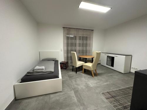 - une chambre avec un lit, une table et des chaises dans l'établissement Luxus Apartment, à Oberhausen