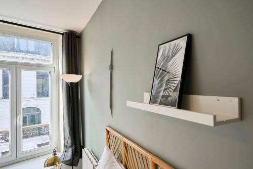 a room with a window and a shelf on the wall at Lille Train station nice studio in Lille
