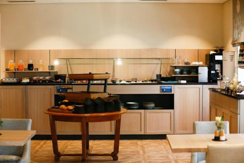a kitchen with a table in the middle of a room at Hotel Lutz in Rain