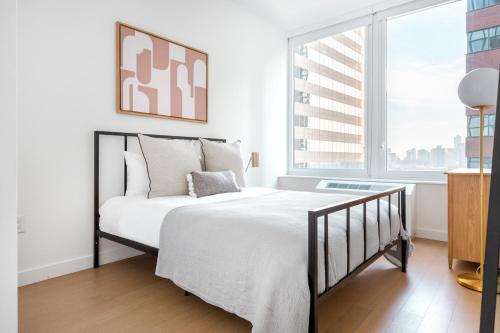 a bedroom with a bed and a large window at FiDi 1BR w Gym WD nr S St Seaport NYC-536 in New York