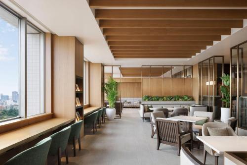a restaurant with tables and chairs and windows at The Westin Tokyo in Tokyo