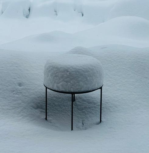 a snow covered stool sitting in the snow at "Panorama" Kakhri in Mestia