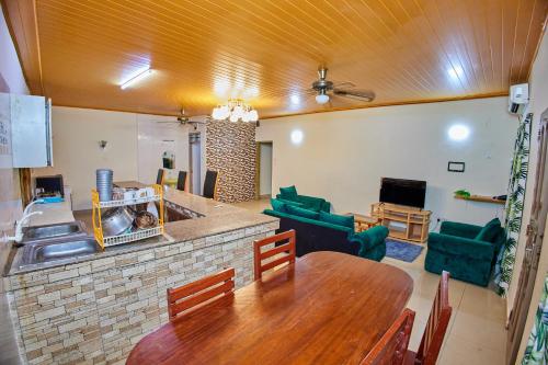 a kitchen and living room with a table and a couch at Diani Home Stays in Diani Beach