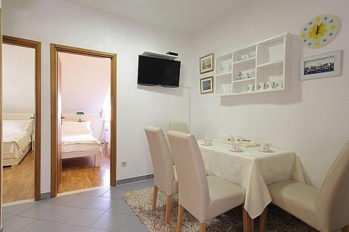 a dining room with a table and chairs and a bedroom at Apartment Kovac Old Town 2 in Dubrovnik