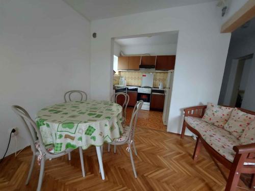 a kitchen and dining room with a table and chairs at Apartment in Njivice/Insel Krk 33552 in Njivice