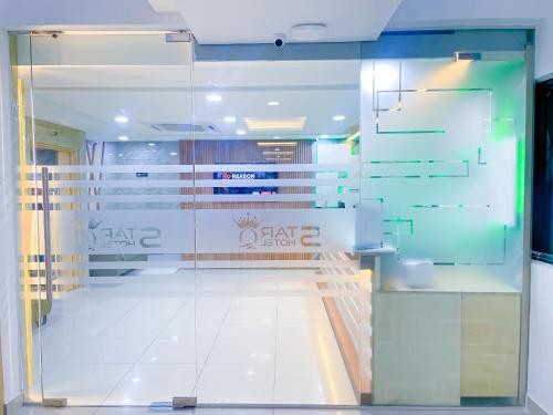 a hallway with a glass door in a building at StarQ Hotel Bukit Bintang in Kuala Lumpur