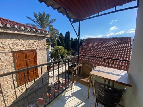 a balcony of a house with a table and chairs at Camel Apartment in Antalya