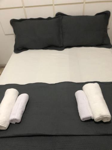 מיטה או מיטות בחדר ב-Barra da Tijuca