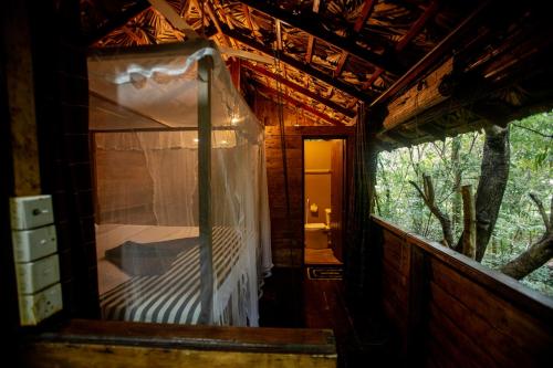 an outside view of a bedroom in a tree house at INN On The Tree Eco Resort Sigiriya in Sigiriya