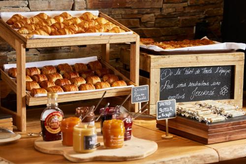 a bakery with various types of bread and other pastries at Hôtel L'Arboisie in Megève