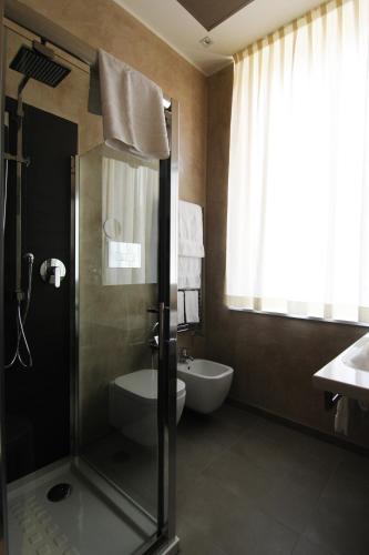 a bathroom with a shower and a toilet and a sink at Sole Hotel Verona in Verona
