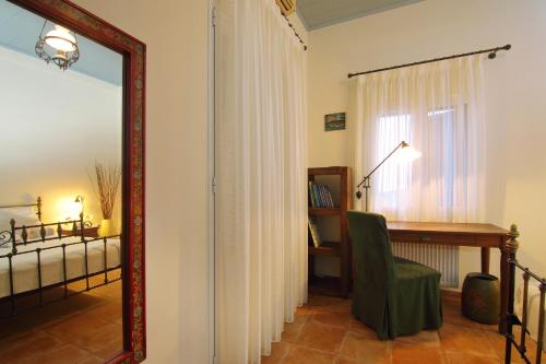 a room with a mirror and a desk and a bed at Villa Spilies Kythira in Kýthira