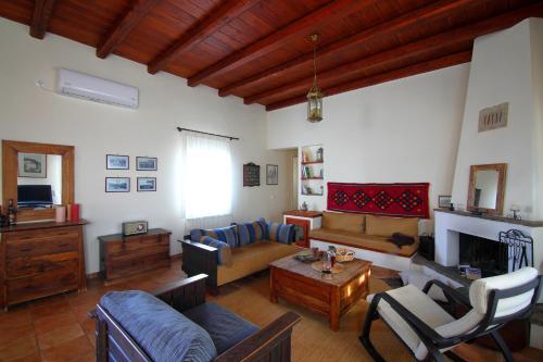 a living room with a couch and a table at Villa Spilies Kythira in Kýthira