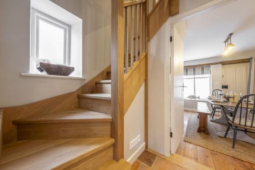 a hallway with stairs leading to a dining room at 12 Station Road in Holt