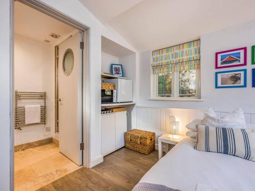 a bedroom with a white bed and a window at Pass the Keys Delightful Studio in West Ashling in Chichester