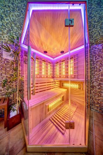 a room with a sauna with purple lights at Oak Residence Hotel & Relax in Smolyan