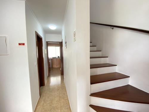 a hallway with stairs in a house at Luz's Retreat Apartment in Ponta Delgada