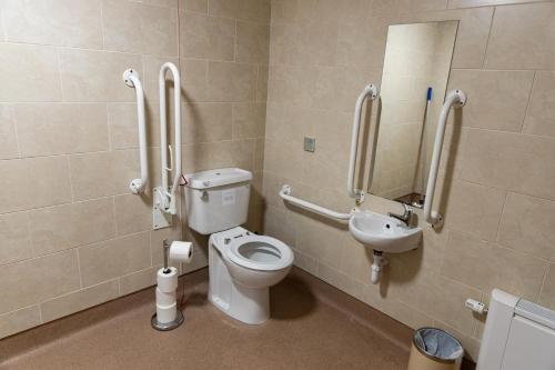 a bathroom with a toilet and a sink at Cliff College in Curbar