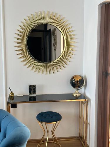 a living room with a blue stool and a mirror at APARTMANI JERKOVIĆ - DUNAV 2 in Vukovar